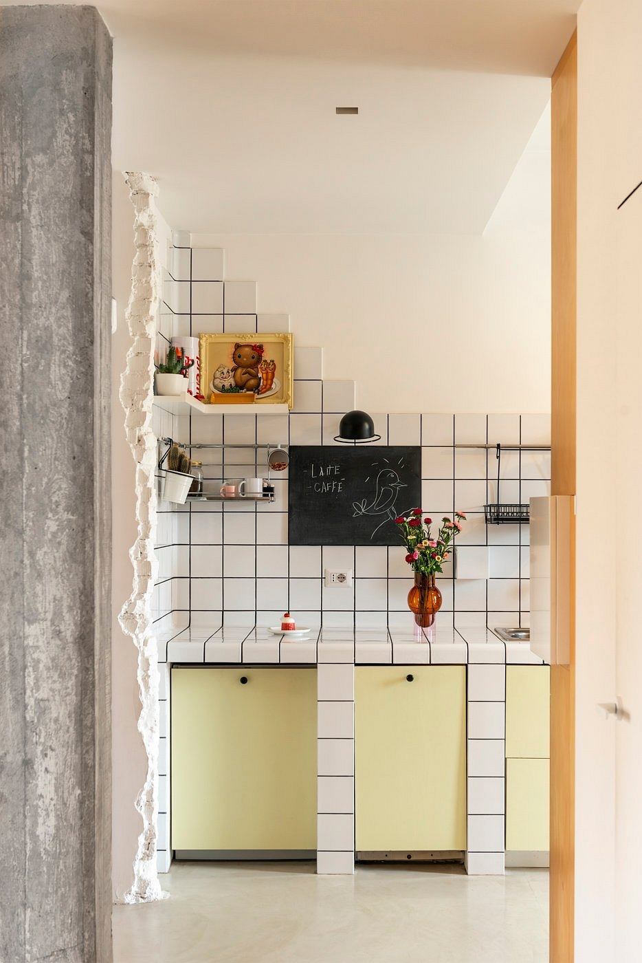 Stylish kitchen with geometric tile pattern, minimalist shelves, and an eclectic decor.