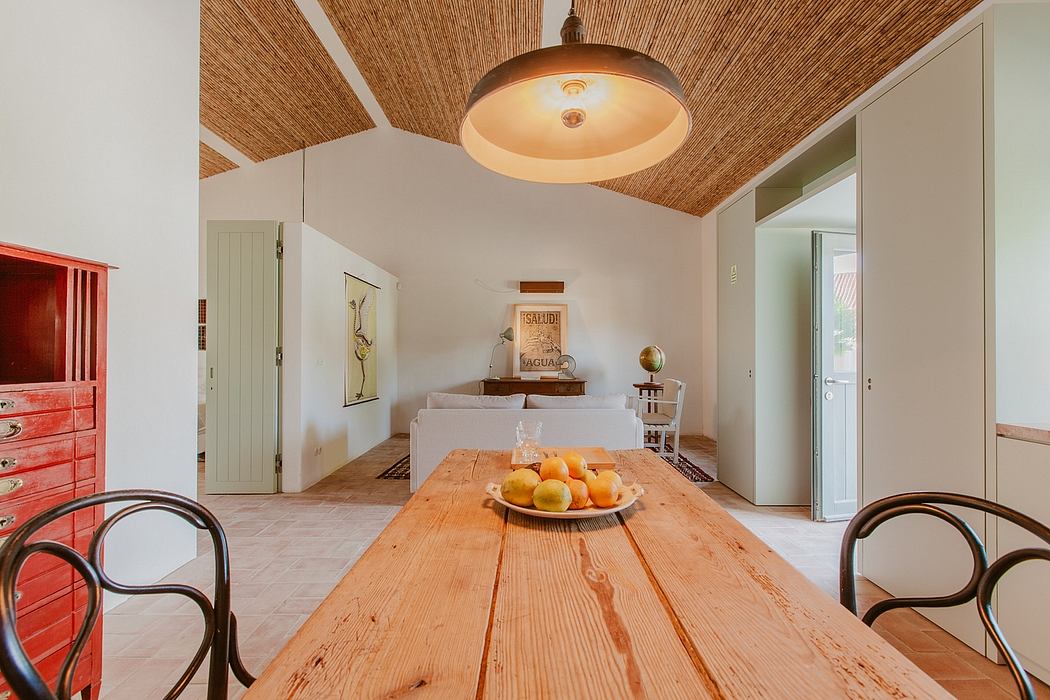 A cozy room with rustic wooden furniture, warm lighting, and a vibrant fruit display.