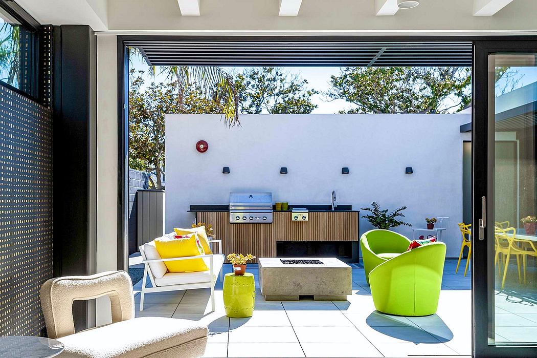 Sleek, modern outdoor living space with contemporary furniture, grill, and open view.