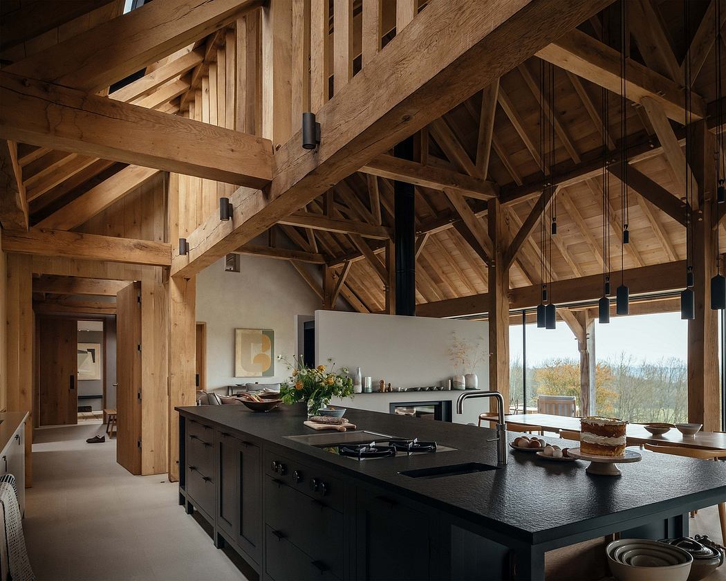 A spacious kitchen with exposed wooden beams, dark cabinetry, and a central island.