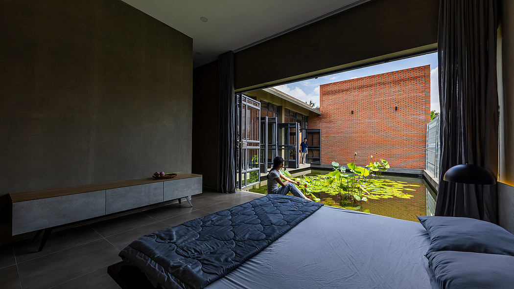 Expansive indoor-outdoor living space with brick, glass, and concrete elements.