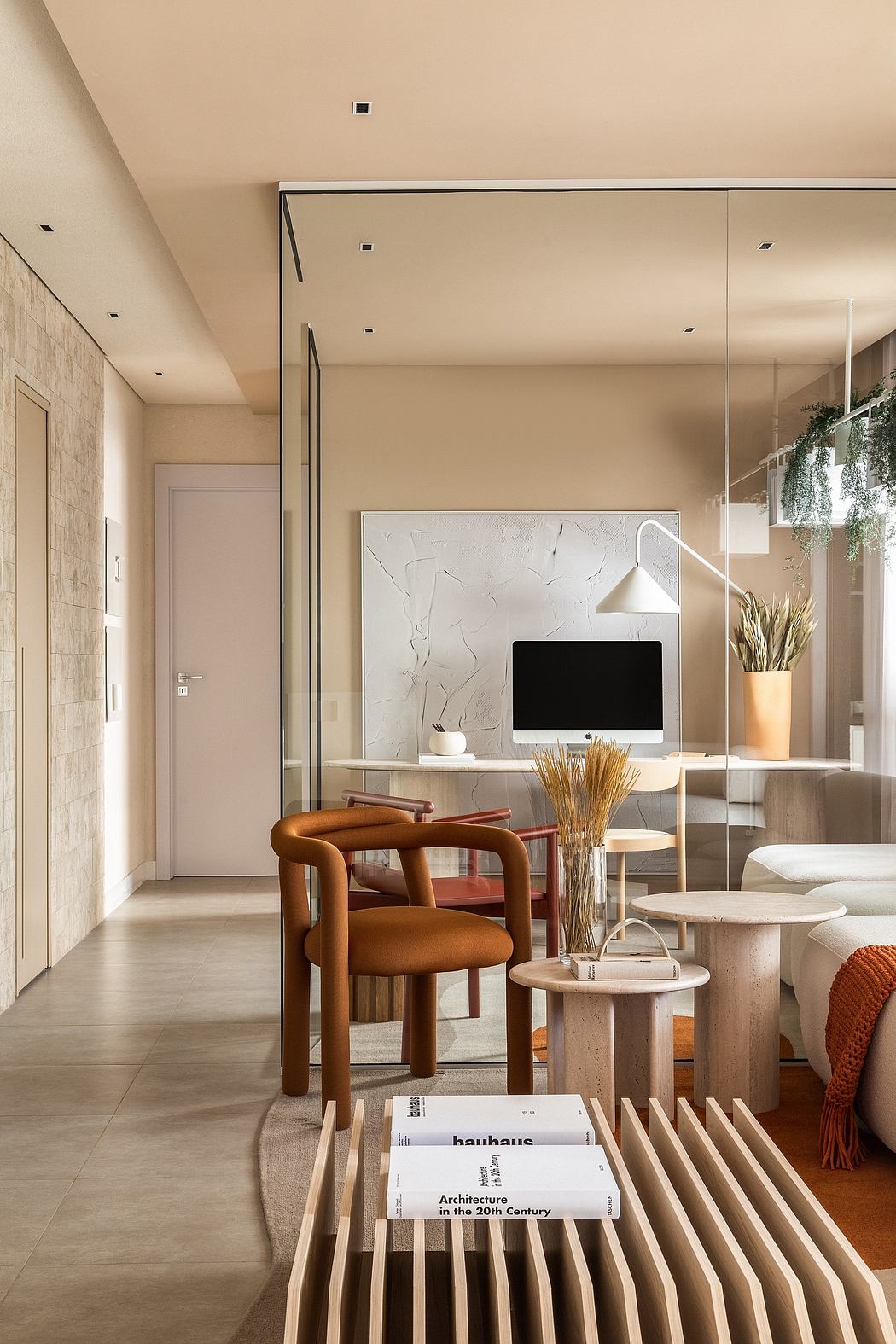 Minimalist interior design with beige walls, wooden furniture, and architectural books.