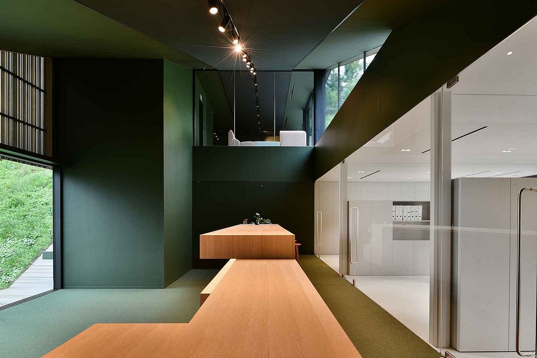 Dramatic, modern interior with bold green and wood tones, sleek appliances, and floor-to-ceiling windows.