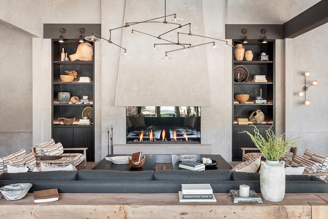 A modern, minimalist living room with a statement fireplace and built-in shelves.