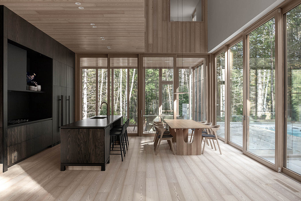 Spacious, minimalist interior with large windows overlooking lush forest, wooden accents.