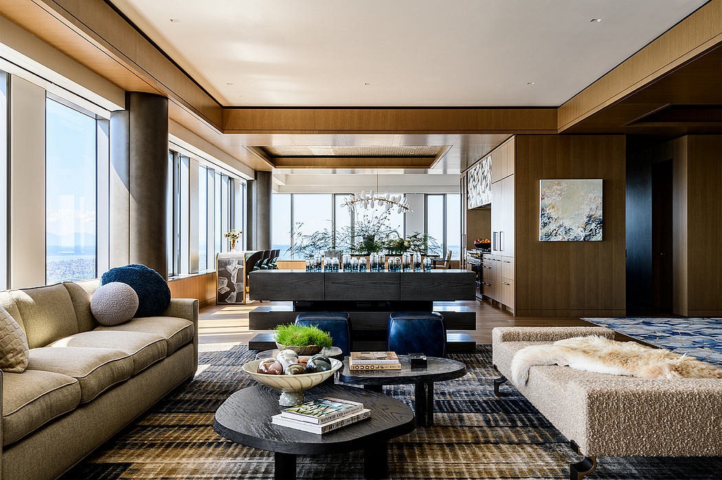 A spacious, modern living room with floor-to-ceiling windows, wooden accents, and a sleek bar area.