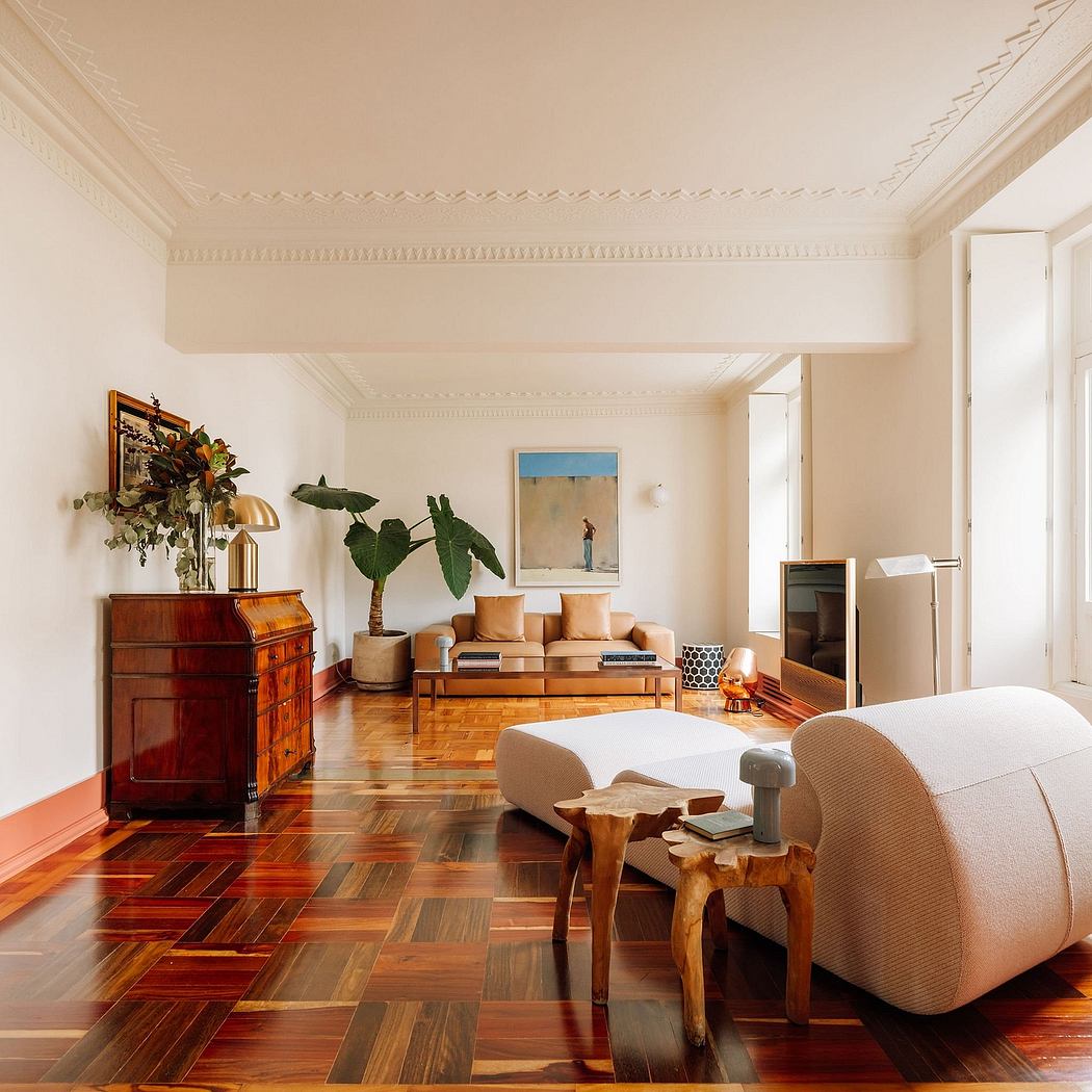 Elegant living room with ornate ceiling molding, hardwood floors, and vintage furnishings.