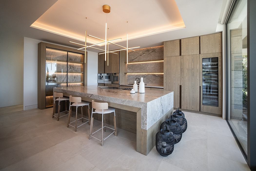 A modern and sleek kitchen with wooden cabinets, a large stone island, and sophisticated lighting.