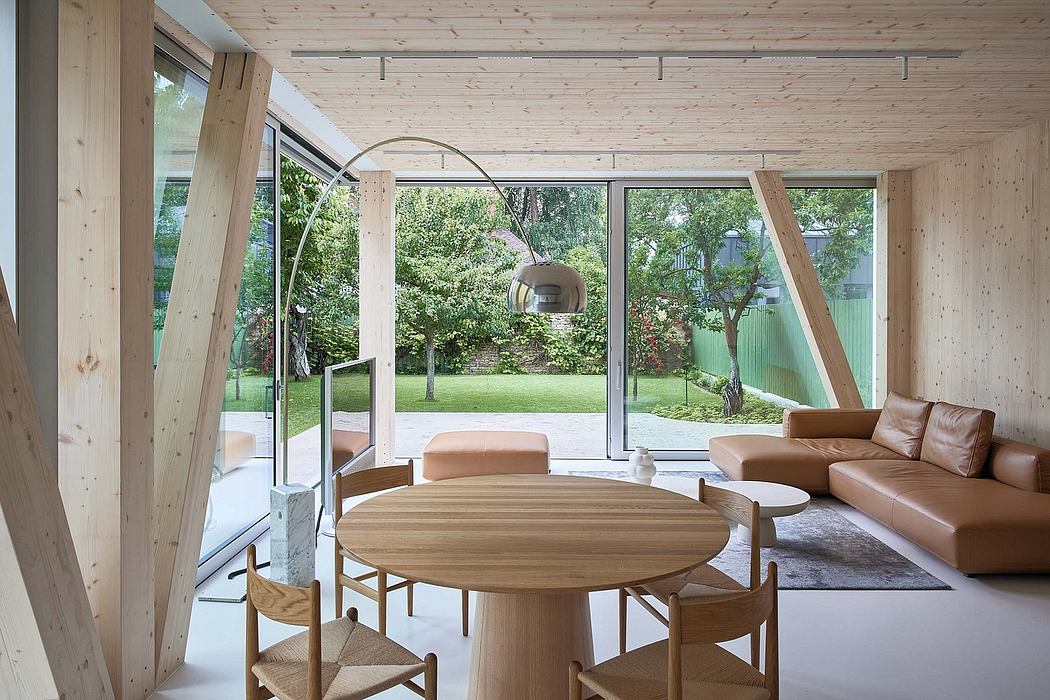 Spacious wooden interior with expansive garden view, modern furniture and lighting.