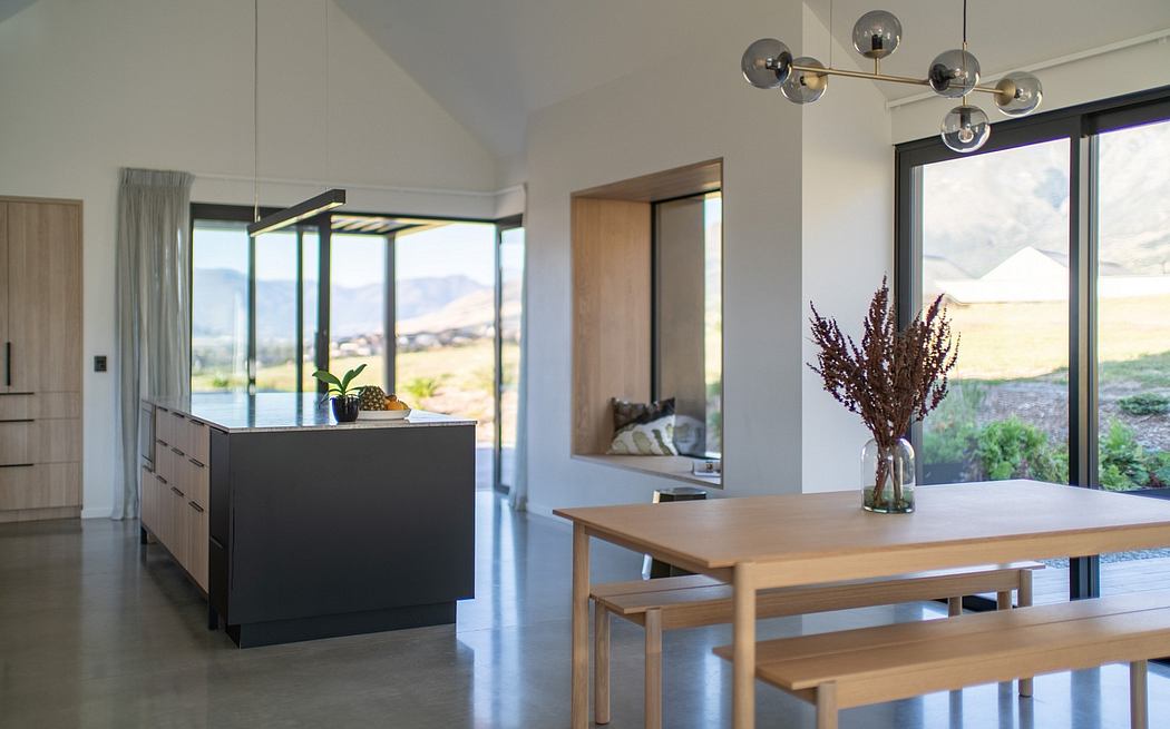 Bright, modern kitchen with sleek cabinetry, pendant lighting, and panoramic views.
