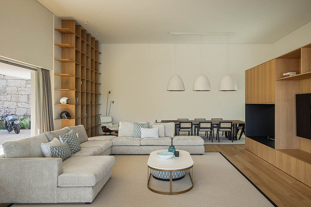 Spacious living room with ample shelving, neutral color palette, and stylish lighting fixtures.