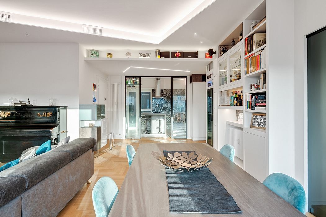 Bright, modern open-concept living space with built-in shelving, wood floors, and colorful decor.