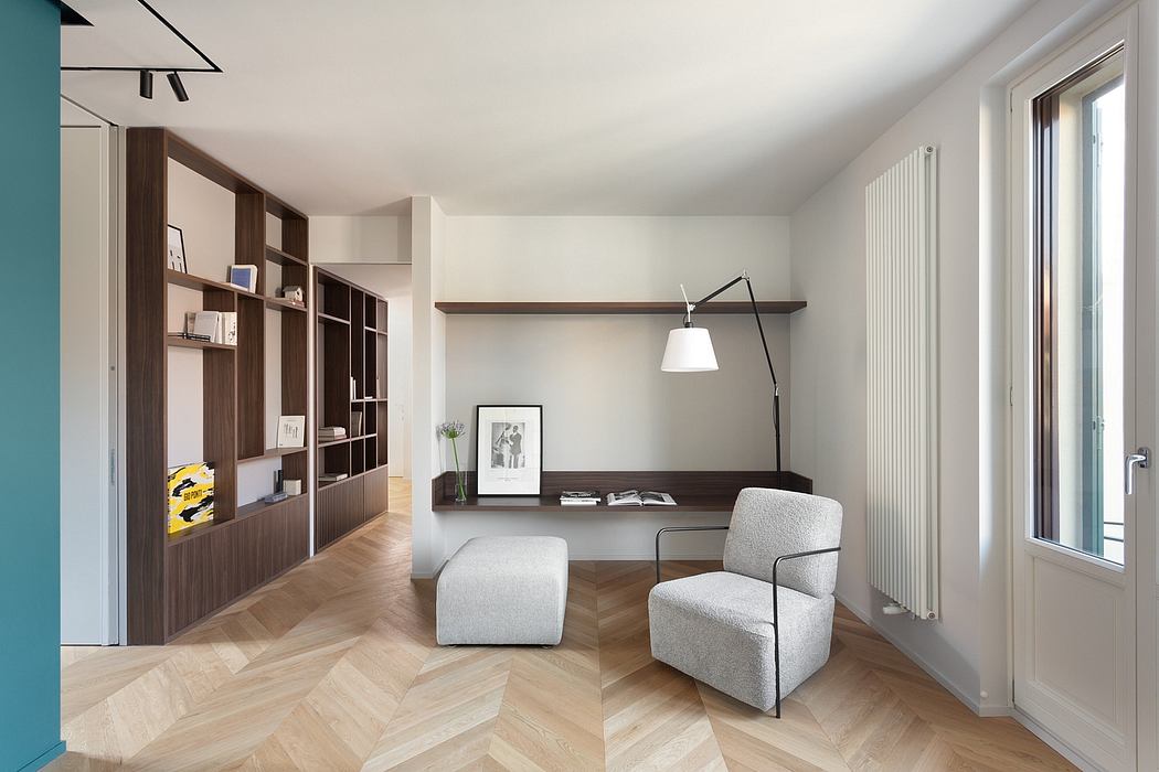Minimalist home office with wood shelving, floating desk, and Scandinavian-inspired armchair.