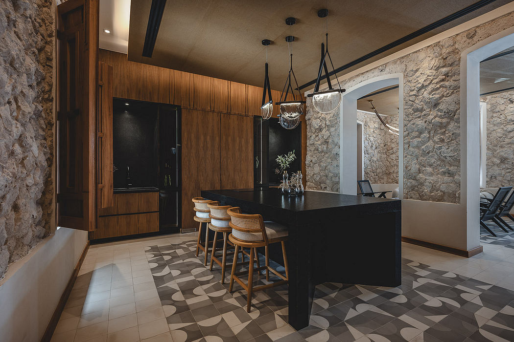 Striking stone walls, sleek black cabinetry, and contemporary lighting create a stylish interior.