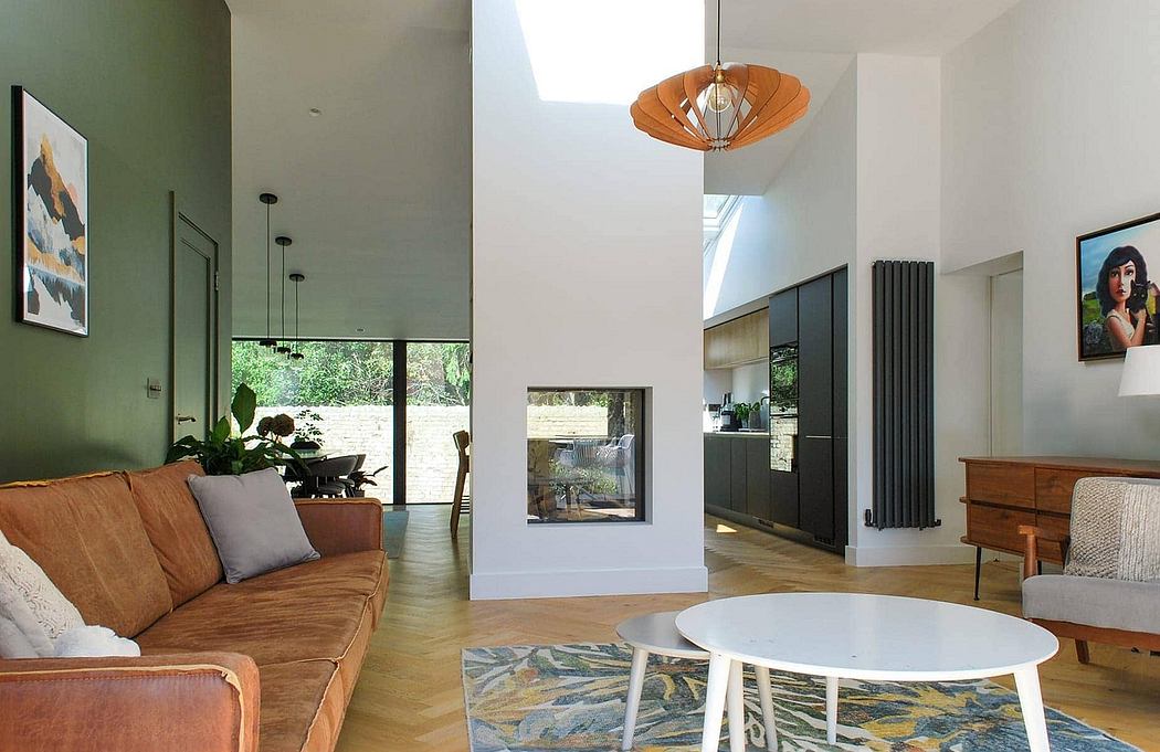 Modern, open-concept living room with a large window, wooden floors, and a geometric light fixture.