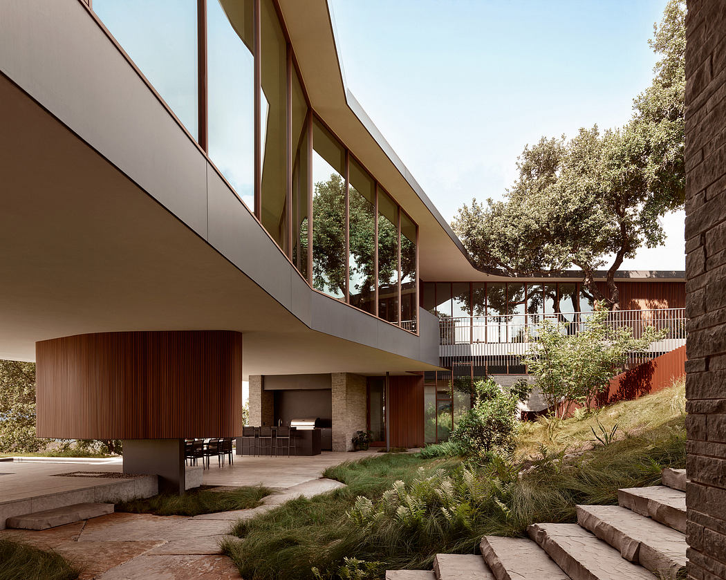 Modern architectural design with glass walls, wood accents, and lush landscaping.