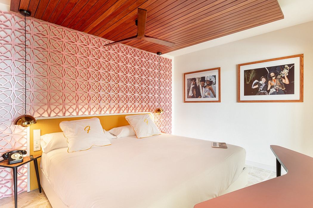 A cozy bedroom with a wooden ceiling, intricate wall patterns, and framed wall art.