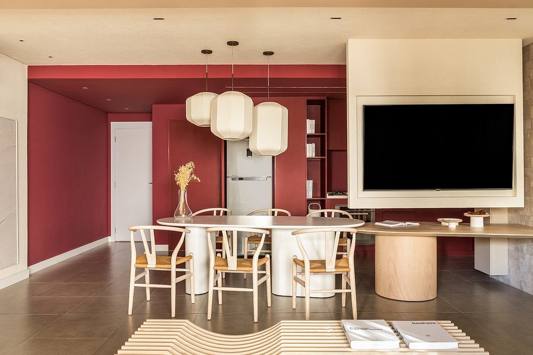 Contemporary dining space with bold red walls, pendant lighting, and a minimalist table setup.