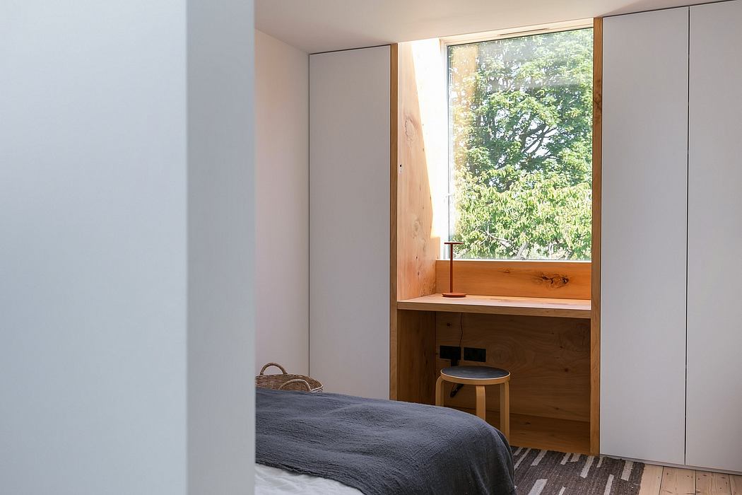 A cozy minimalist bedroom with floor-to-ceiling windows overlooking nature.