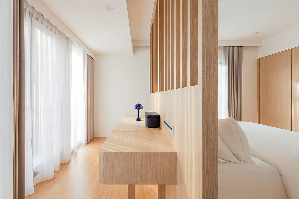 Minimalist bedroom with wooden accents, built-in shelves, and floor-to-ceiling windows.