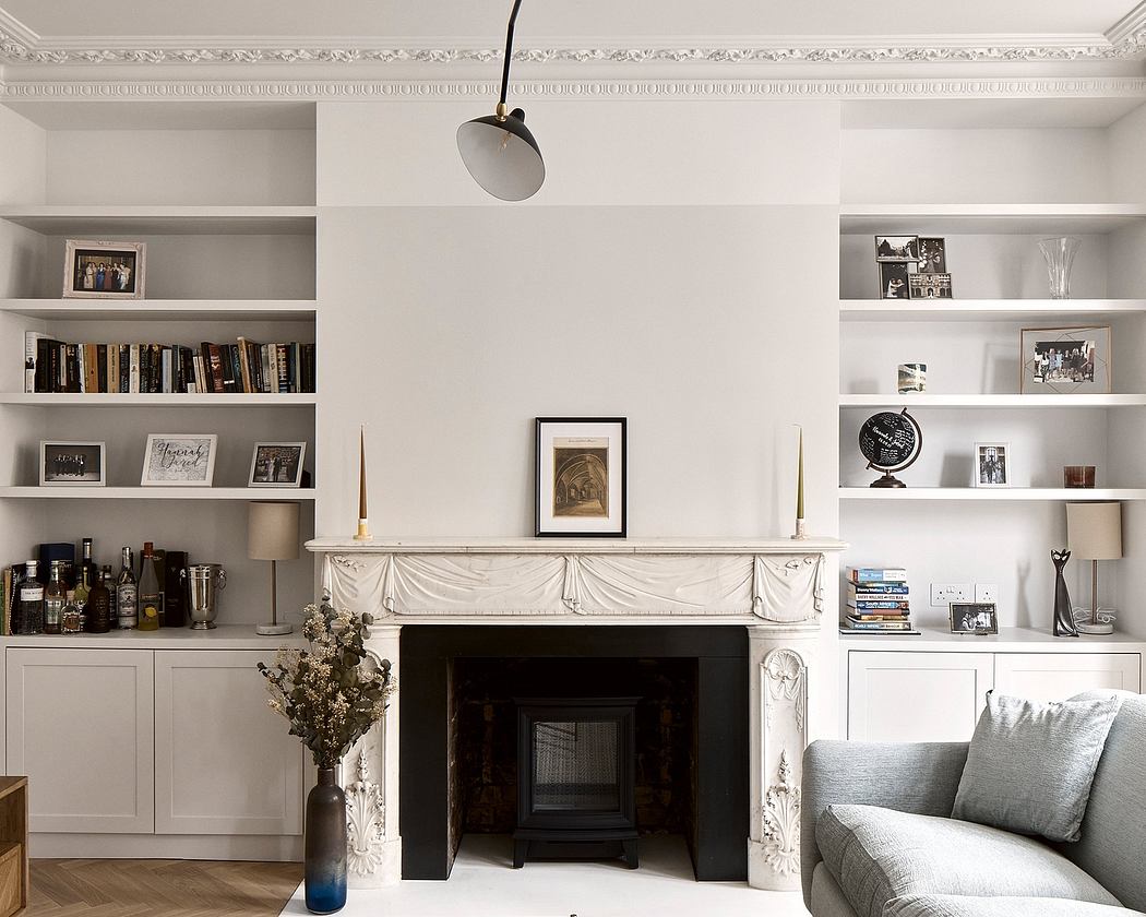 Elegant living room with ornate fireplace, built-in shelves, and tasteful decor.