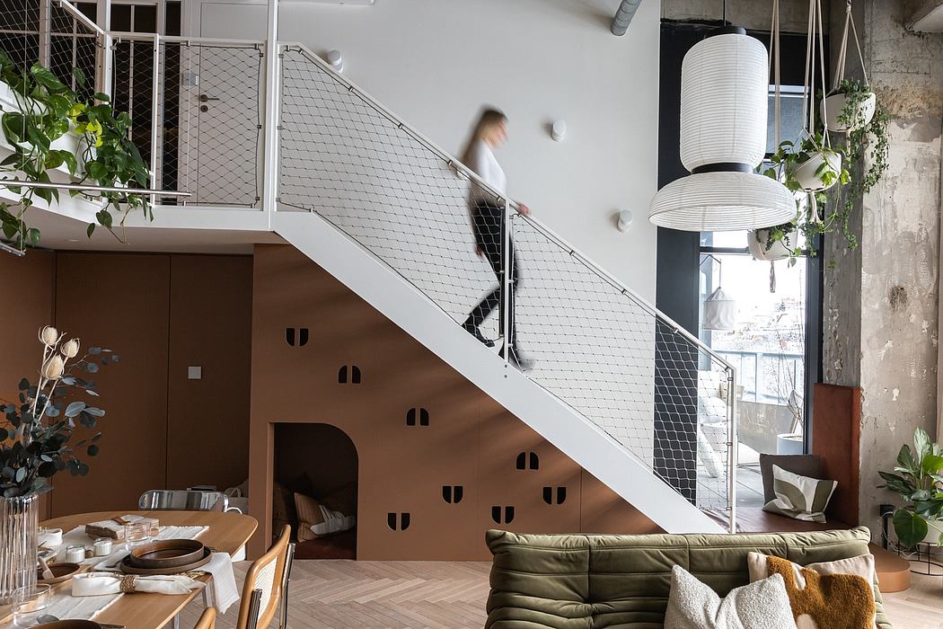 Minimalist interior with exposed brick, metal staircase, and natural lighting.