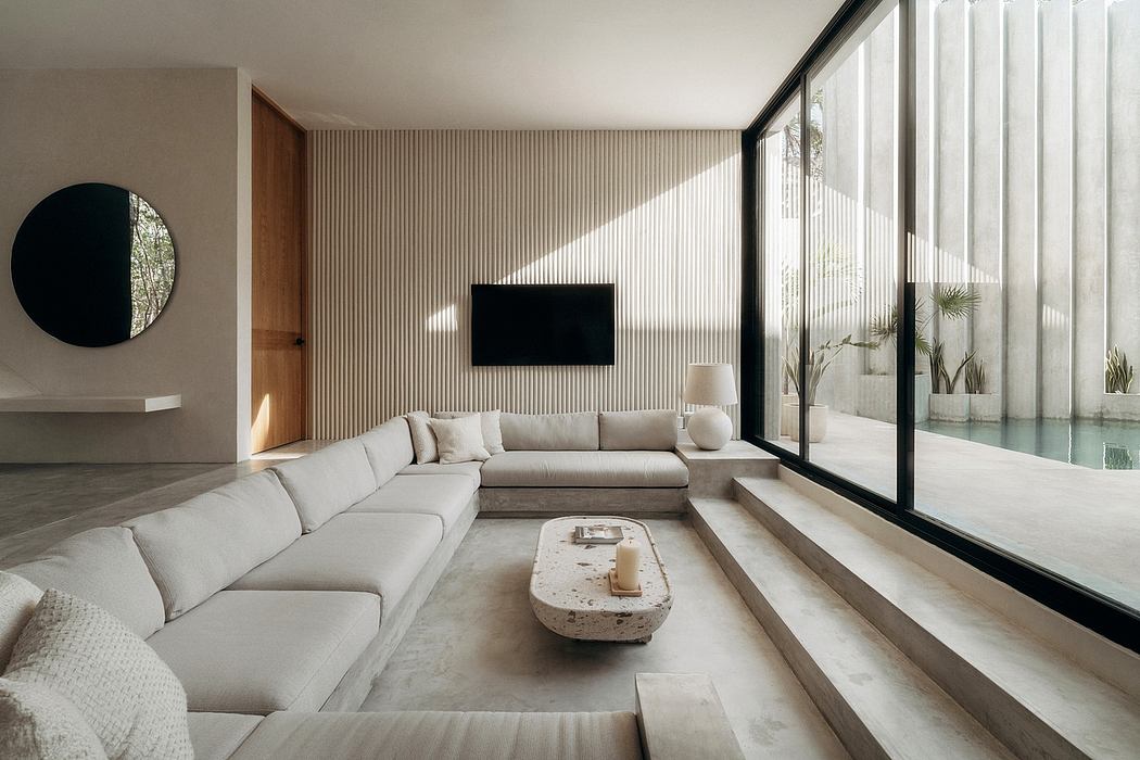 Elegant modern living room with sleek furniture, textured walls, and expansive windows.