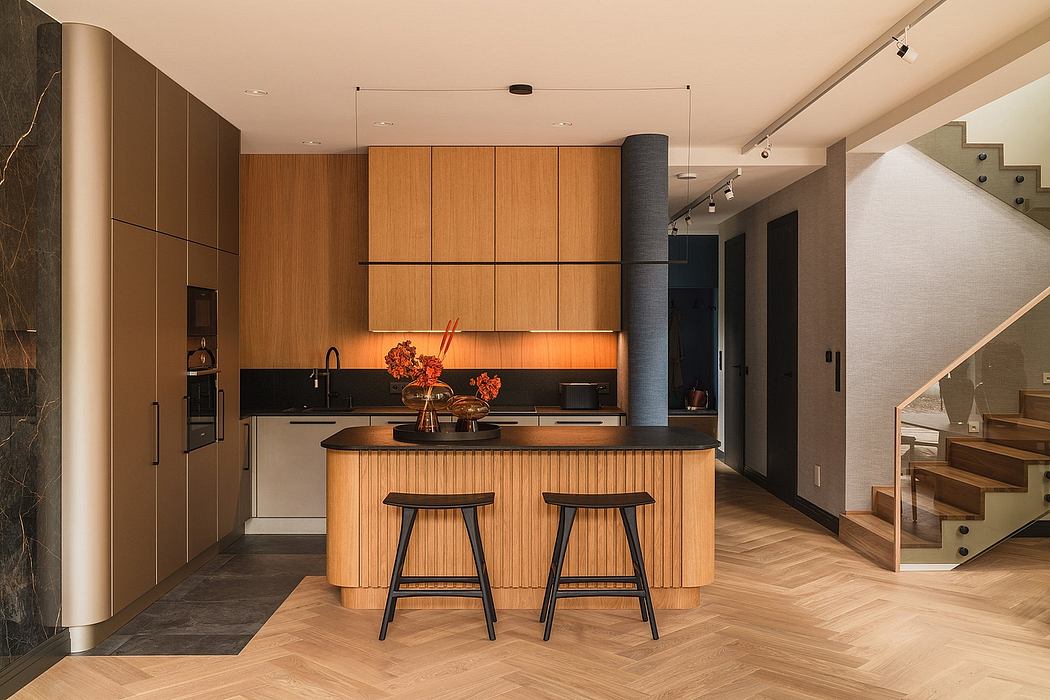 A modern kitchen with wooden cabinetry, black countertops, and stylish pendant lighting.