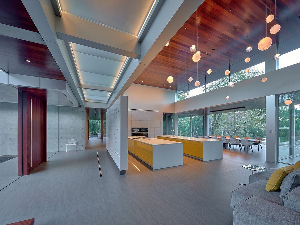 A spacious, modern interior with a sleek kitchen, high ceilings, and pendant lighting.