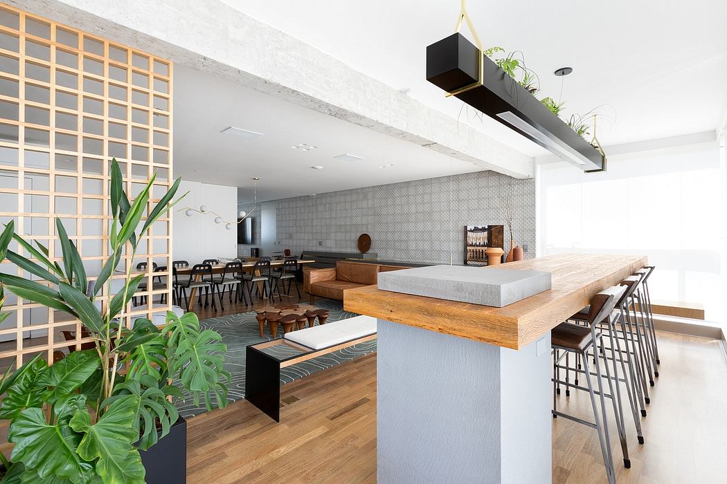 Minimalist, industrial-style interior with concrete, wood, and greenery accents.