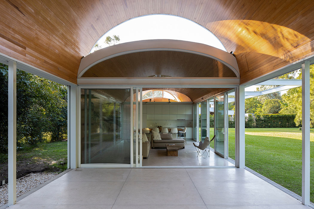 Elegant arched doorway framing a modern, open-concept living space with sliding glass doors.
