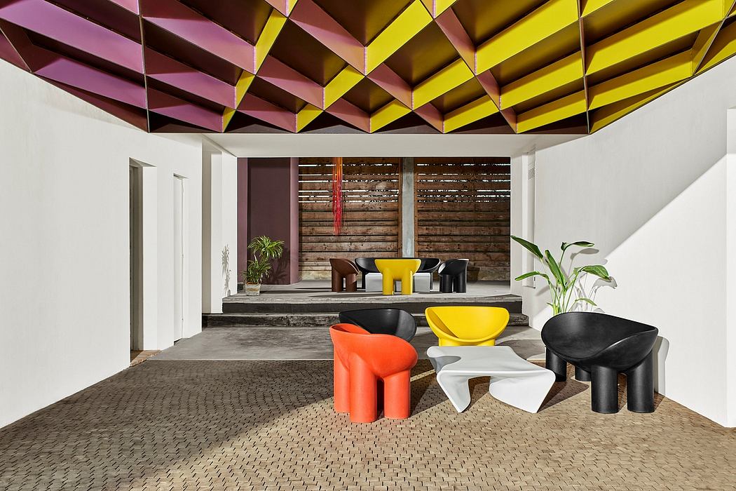 Vibrant geometric ceiling contrasts with rustic wood walls in modern interior design.