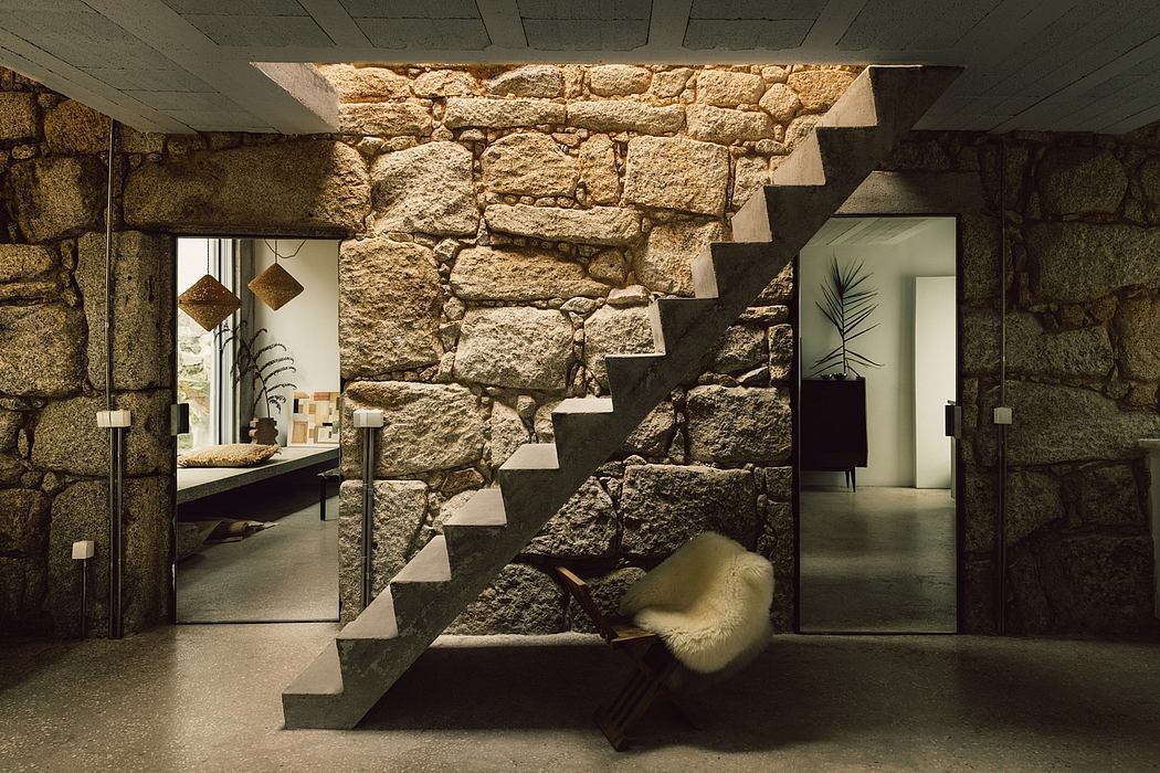 A modern stone staircase with minimalist furnishings and decor in a rustic interior.