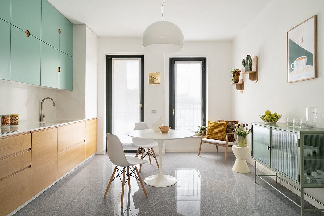 Open-concept kitchen and dining area with minimalist decor, natural wood cabinets, and modern furnishings.