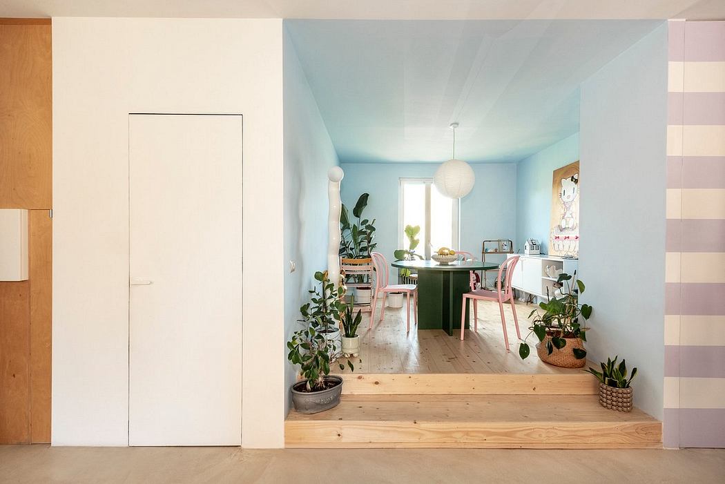 Cozy and vibrant living space with pastel walls, natural wood flooring, and potted plants.