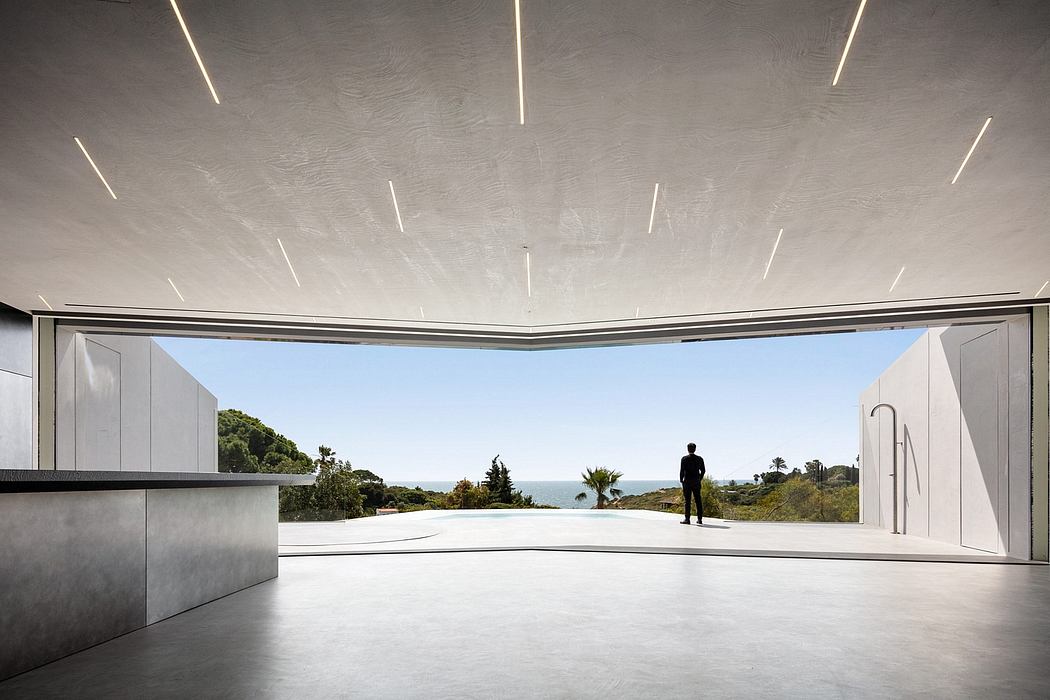 Sleek, modern interior with expansive ocean view and minimalist lighting design.