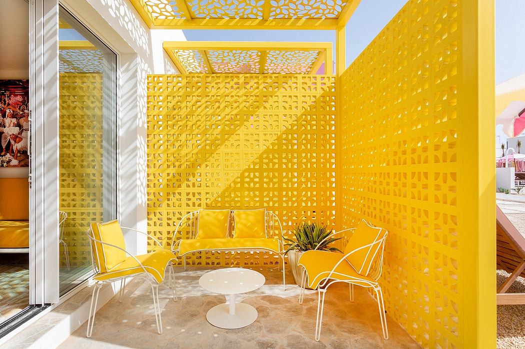 Vibrant yellow perforated panels create a modern, sun-drenched outdoor seating area.