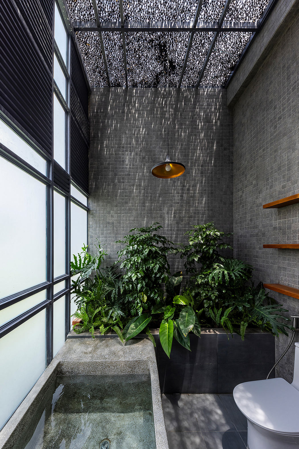 Sleek minimalist bathroom with lush greenery, textured walls, and modern lighting.