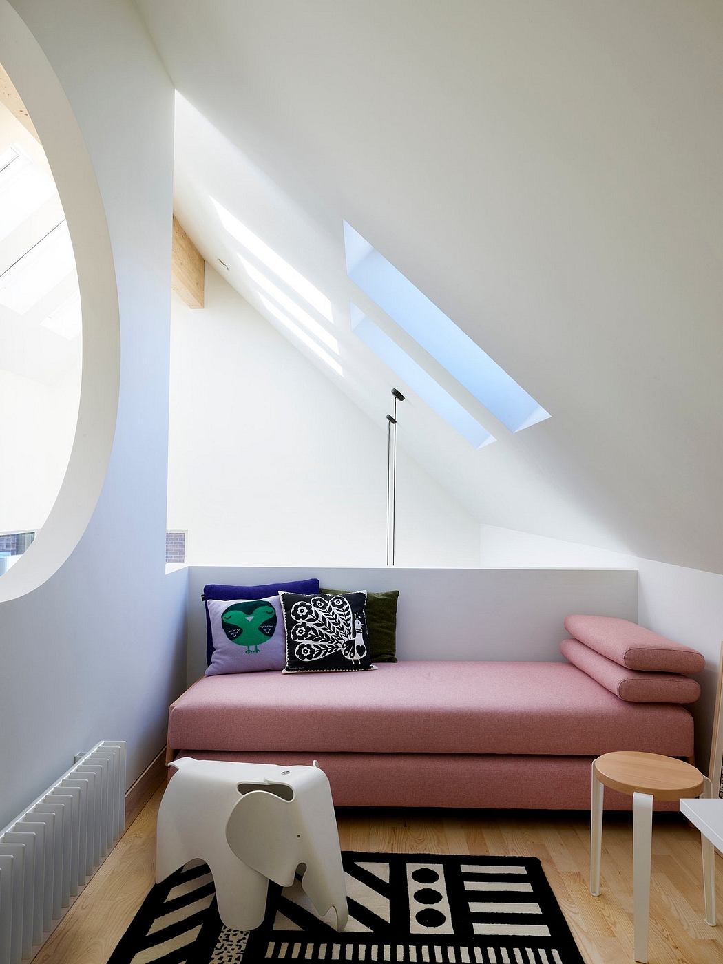 Minimalist living space with dramatic architectural elements and vibrant furnishings.