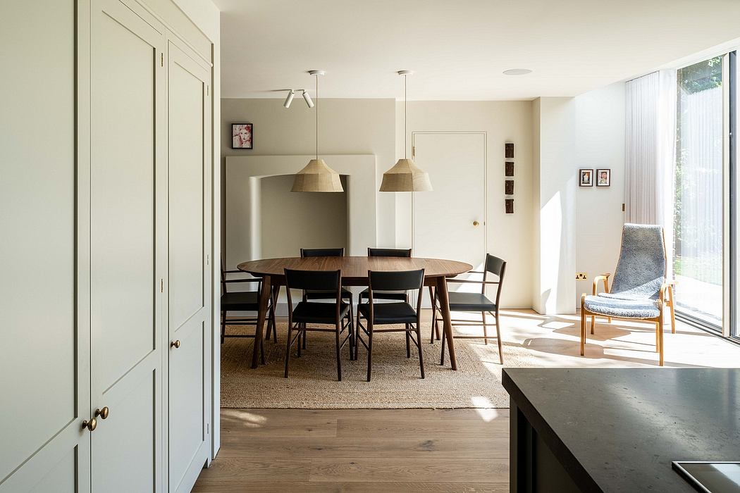 Cozy dining room with wooden table, pendant lights, and neutral-toned decor.