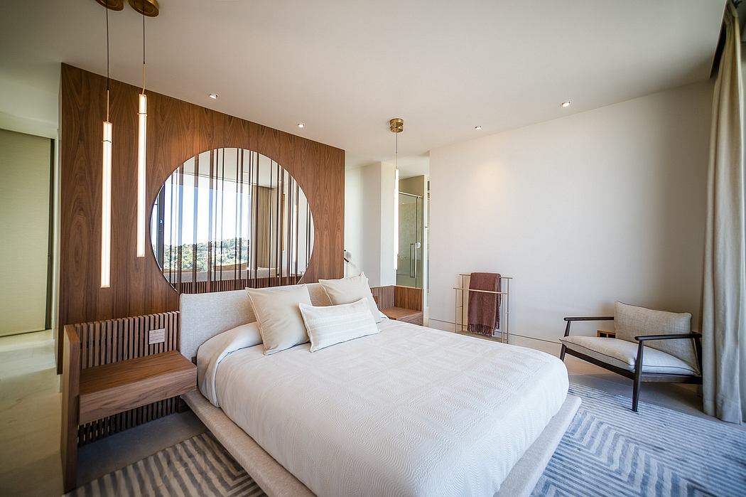 Spacious bedroom with modern wooden wall paneling, arched window, and pendant lights.