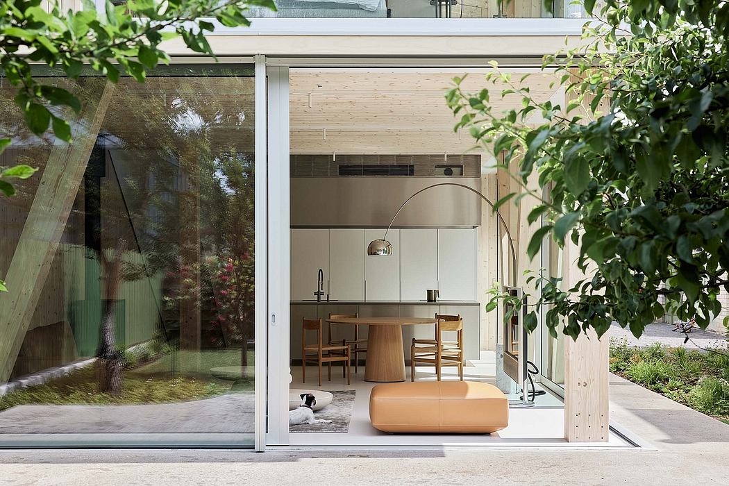 A modern, minimalist open-plan design with large glass walls, wood accents, and minimalist furniture.