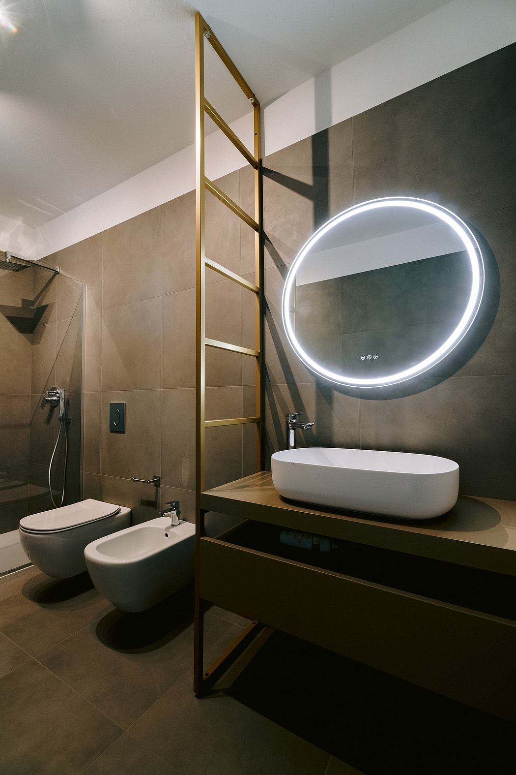 Minimalist bathroom with sleek circular mirror, floating vanity, and metal ladder shelving.