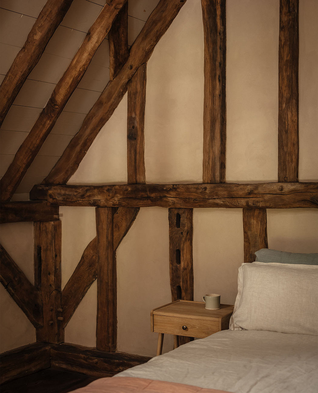Rustic wooden beams and neutral tones create a cozy, inviting bedroom atmosphere.