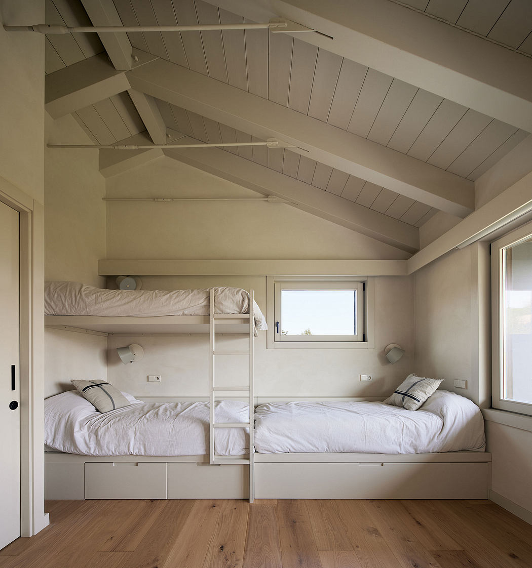 Cozy bedroom with slatted ceiling, bunk beds, and built-in storage drawers.