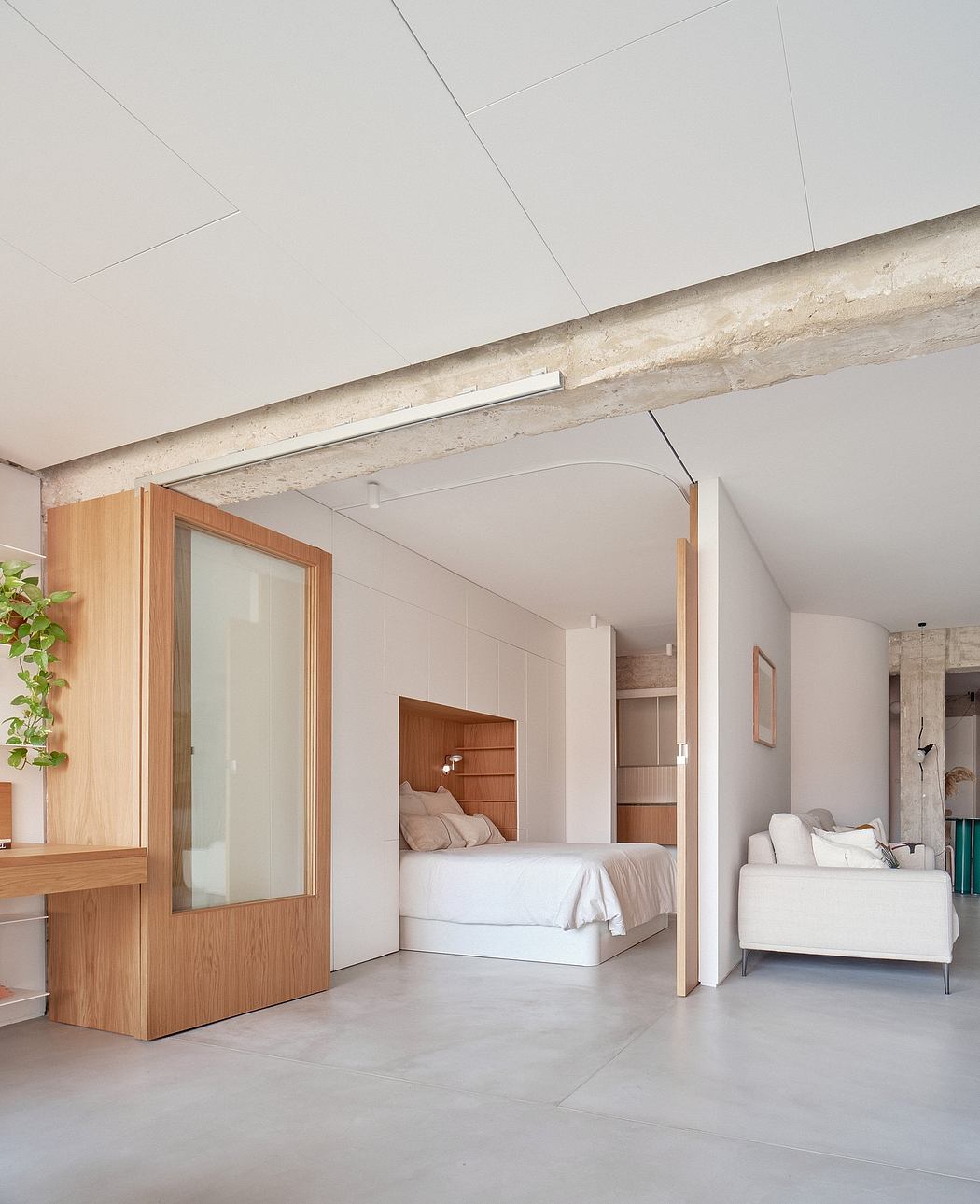 Minimalist bedroom design with exposed concrete beam, wood and glass accents.