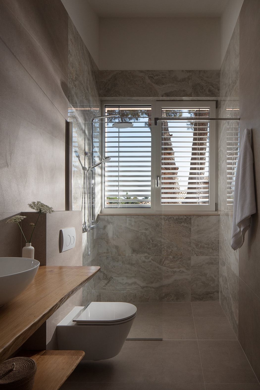 Sleek, modern bathroom with minimalist fixtures, wood accents, and a large window.