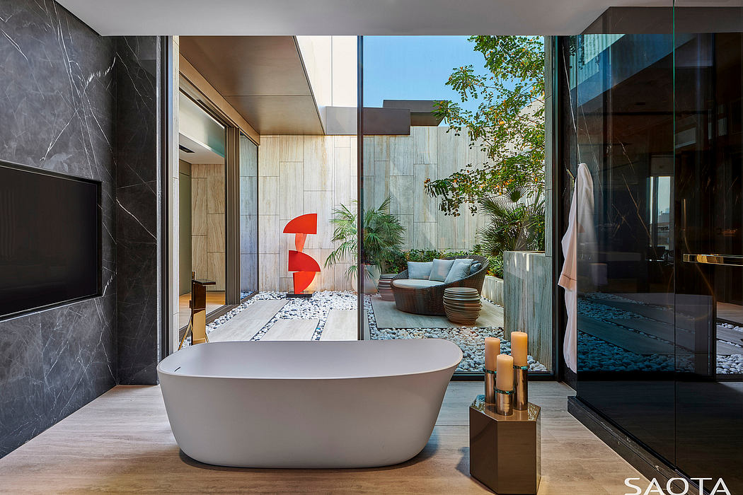 Sleek modern bathroom with minimalist freestanding tub and lush outdoor courtyard view.
