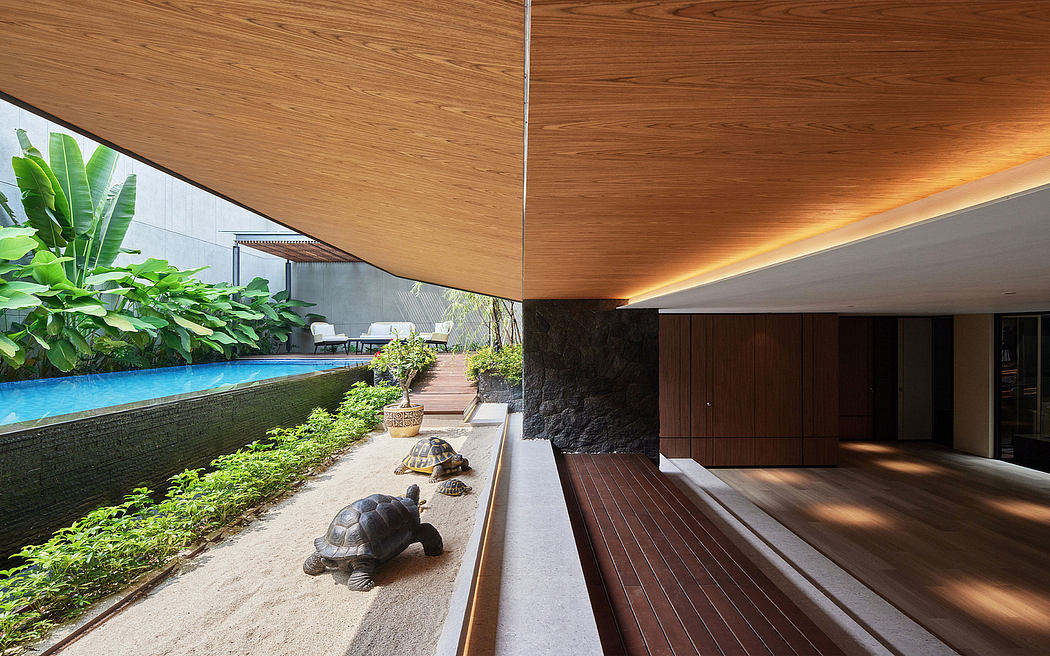 Serene outdoor pool area surrounded by lush greenery and wooden decking with unique architectural elements.