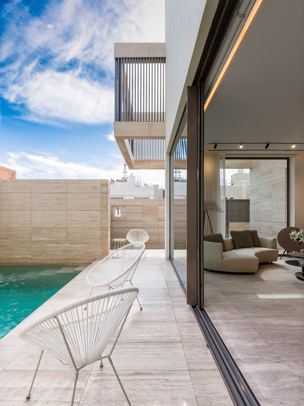 Sleek modern architecture with minimalist furniture, pool, and expansive views.